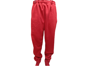 Unisex red jogger pants with tonal embossed logo, tapered fit, ribbed cuffs, and drawstring waist for casual streetwear style
