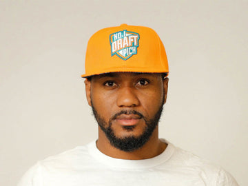 Bright orange cap with embroidered “Miami” text, curved brim, and adjustable strap for bold, unisex streetwear style