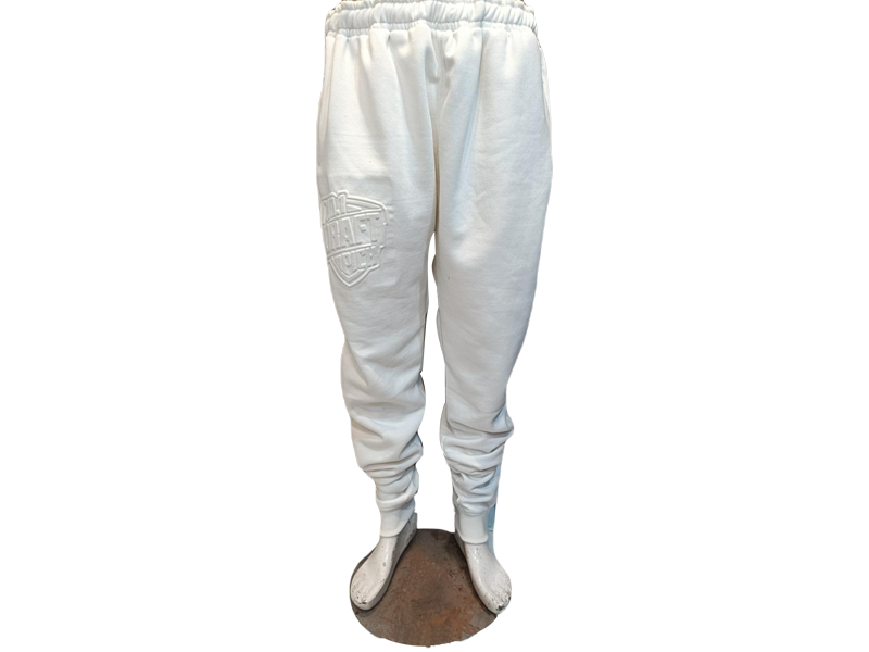 Unisex off-white jogger pants with tonal embossed branding, tapered fit, ribbed cuffs, and drawstring waist for clean, minimalist style