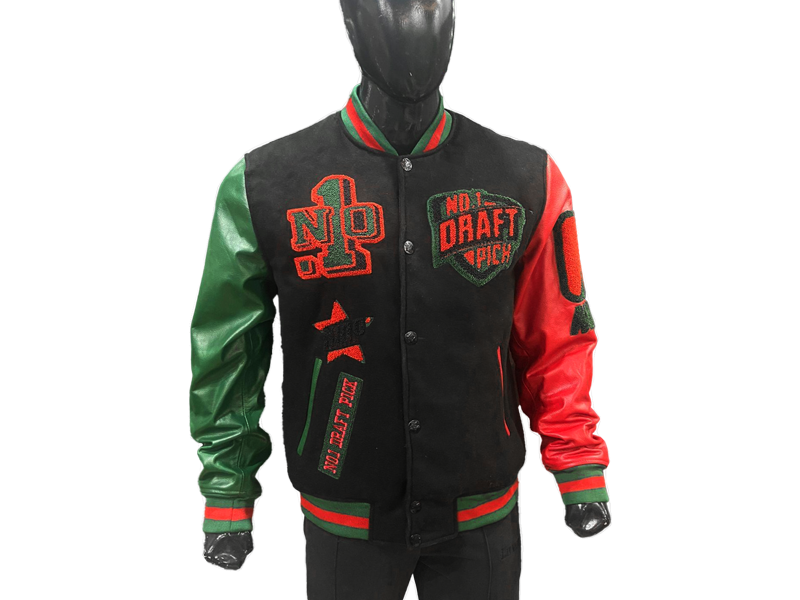Unisex varsity jacket featuring a black wool body with red-green detailing, lambskin leather sleeves, and historic-themed embroidery in a premium streetwear style